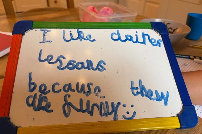 A whiteboard which has a message about Claire's lessons...