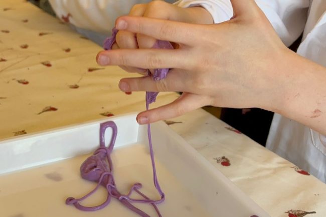 A child's hands on a science workshop run by Claire Brooke