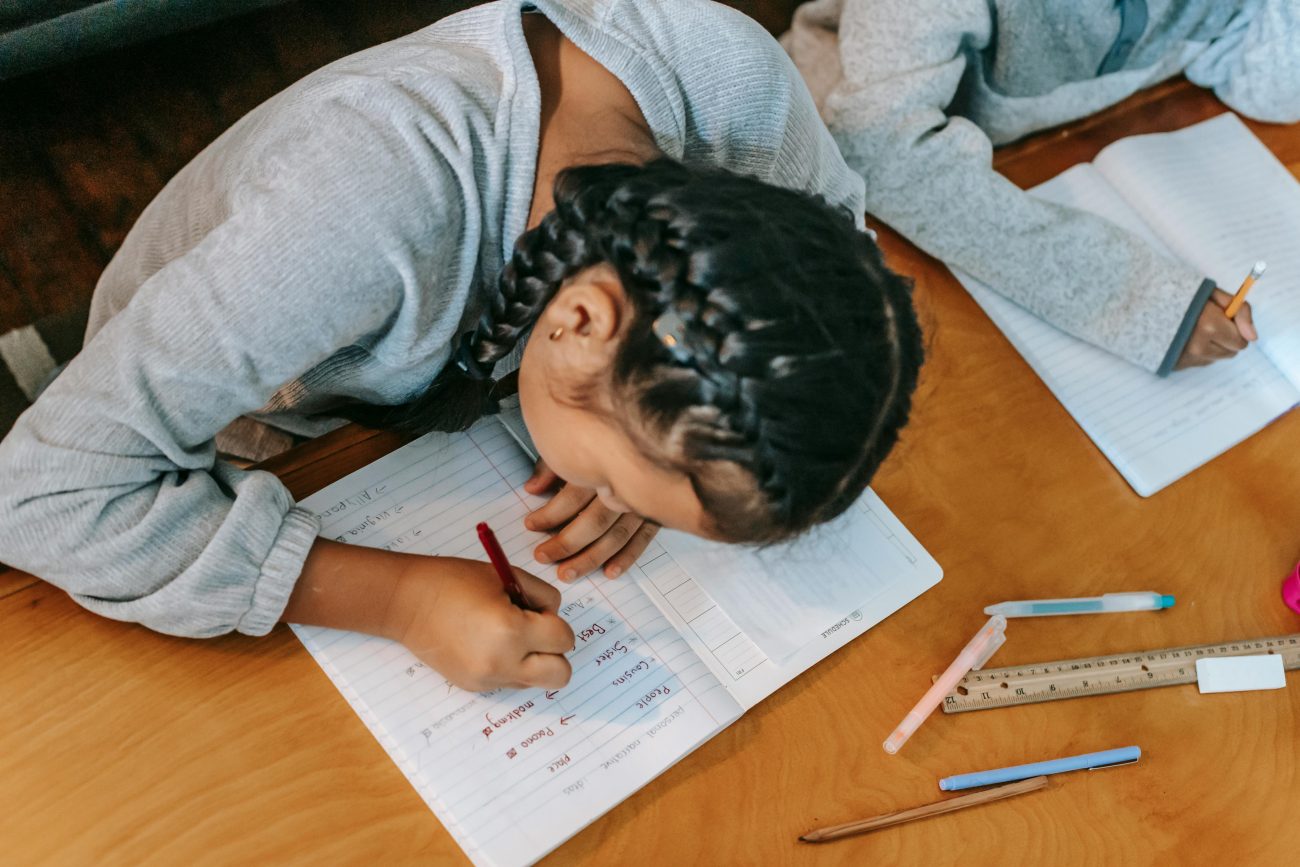 A girl doing her homework at a table.
